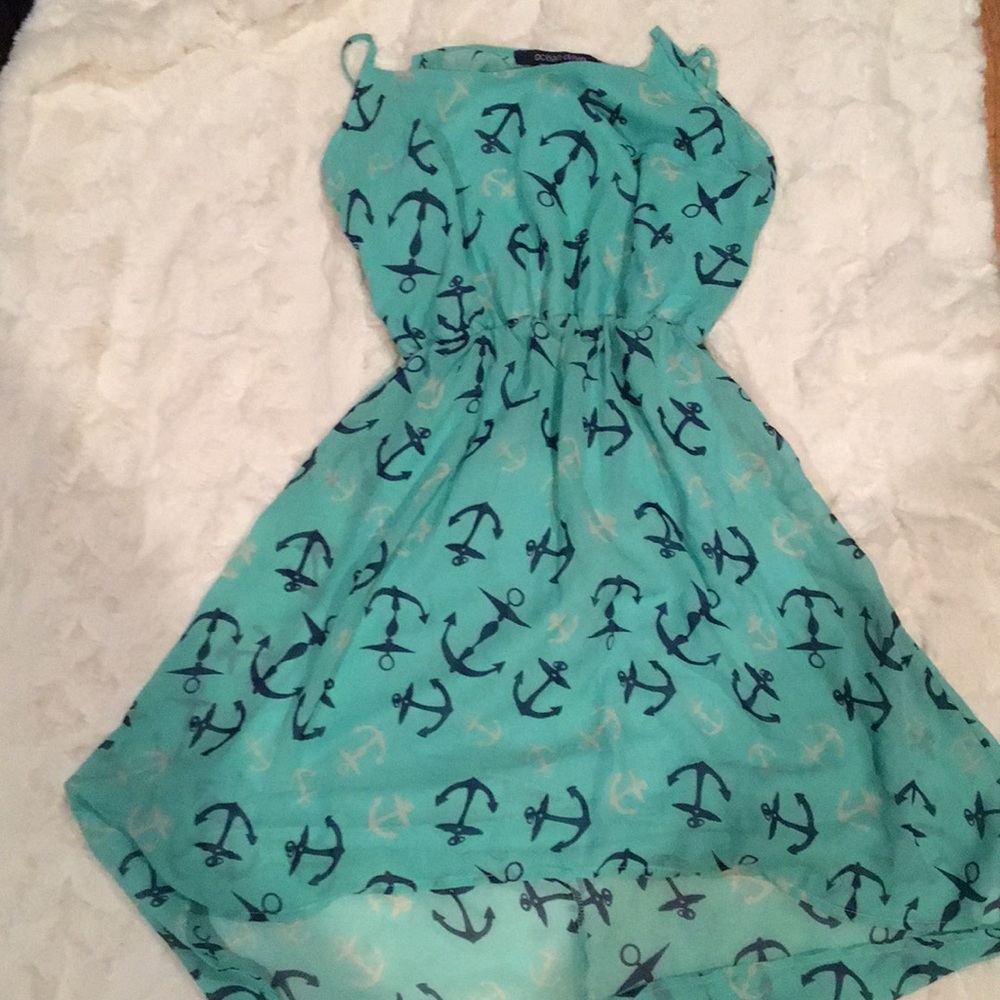 Flowy teal dress with anchors all over.